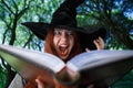 Portrait of witch with open magic book Royalty Free Stock Photo