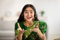 Portrait screen view of cheerful Indian woman in sari dress making video call, using computer from home