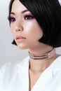 Portrait of seductive brunette asian woman in pink choker