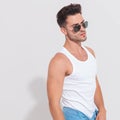 Portrait of seductive muscular man wearing sunglasses and tank t Royalty Free Stock Photo
