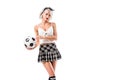 portrait of seductive woman in plaid schoolgirl skirt with football ball