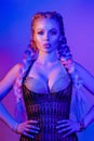 Portrait of seductive young European woman surrounded by evening neon lights medium close-up Royalty Free Stock Photo