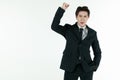 Portrait of self-confidence young and handsome Asian businessman in black suit standing and clench his hands in trust gesture,