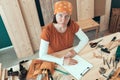 Portrait of self employed female carpenter in her woodwork workshop