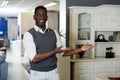 Portrait of seller man who is offering new furniture