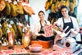 Portrait of sellers offering tasty jamon