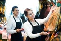 Portrait of sellers offering tasty jamon