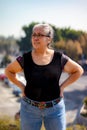 Portrait of senior adult woman standing with blurred cityscape in background