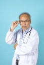 Portrait of senior Asian doctor with serious face standing Royalty Free Stock Photo