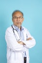 Portrait of senior Asian doctor with serious face standing Royalty Free Stock Photo