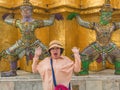 Portrait of Senior asian women make a surprise with Giant lift the pagoda in Wat Phrakaew temple Bangkok Thailand