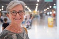 Portrait of senior attractive woman enjoying shopping in a mall, smiling looking at camera. Happy gray haired people Royalty Free Stock Photo