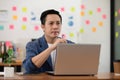 Portrait of Senior business Asian man working with laptop thinking business plan and holding pen Royalty Free Stock Photo