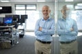 Portrait of senior businessman with arms crossed at modern office Royalty Free Stock Photo