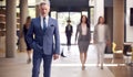 Portrait Of Senior Businessman CEO Chairman Standing In Lobby Of Busy Modern Office Building Royalty Free Stock Photo