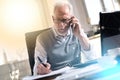 Portrait of senior businessman talking on mobile phone, light effect, , overlayed with network Royalty Free Stock Photo