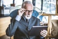 Portrait of senior businessman working on digital tablet. Royalty Free Stock Photo