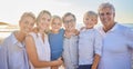 Portrait of a senior caucasian couple at the beach with their children and grandchild. Happy family relaxing on the Royalty Free Stock Photo