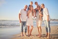 Portrait of a senior caucasian couple at the beach with their children and grandchild. Happy family relaxing on the Royalty Free Stock Photo