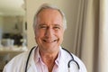 Portrait of senior caucasian male doctor looking at camera and smiling Royalty Free Stock Photo