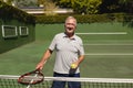 Portrait of senior caucasian man playing tennis on court holding tennis racket Royalty Free Stock Photo