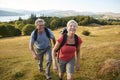 Portrait Of Senior Couple Climbing Hill On Hike Through Countryside In Lake District UK Together Royalty Free Stock Photo