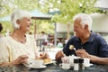 Portrait Of Senior Couple Enjoying Meal At Outdoor Cafe Royalty Free Stock Photo