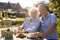 Portrait Of Senior Couple Enjoying Outdoor Summer Snack At Cafe Royalty Free Stock Photo
