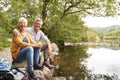 Portrait Of Senior Couple On Hike Sitting By River In UK Lake District Royalty Free Stock Photo