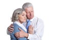 Portrait of senior couple hugging on white background Royalty Free Stock Photo