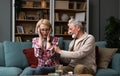 Portrait of senior couple in living room, Mature woman with pain in the shoulder. Upper arm pain, woman neck and shoulder pain and Royalty Free Stock Photo