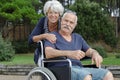 portrait senior couple outdoors man in wheelchair Royalty Free Stock Photo