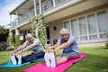 Portrait of senior couple performing stretching exercise on exercise mat Royalty Free Stock Photo