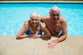 Portrait of senior couple relaxing together in pool Royalty Free Stock Photo