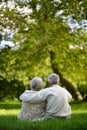 Portrait of senior couple sitting in autumn park Royalty Free Stock Photo