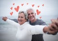 Portrait of senior couple standing with arms outstretched Royalty Free Stock Photo