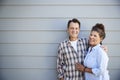 Portrait Of Senior Couple Standing Outside Grey Clapboard House Royalty Free Stock Photo