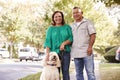 Portrait Of Senior Couple Walking Dog Along Suburban Street Royalty Free Stock Photo