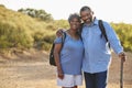 Portrait Of Senior Couple Wearing Backpacks Hiking In Countryside Together Royalty Free Stock Photo