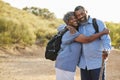 Portrait Of Senior Couple Wearing Backpacks Hiking In Countryside Together Royalty Free Stock Photo