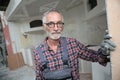 Portrait of senior craftsman on construction site