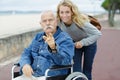 Portrait senior dad in wheelchair daughter outdoors Royalty Free Stock Photo