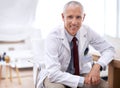 Portrait, senior doctor and happy man in hospital for healthcare, wellness and working in Australia for career. Smile Royalty Free Stock Photo
