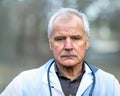 Portrait of a senior doctor looking seriously into the camera. Royalty Free Stock Photo