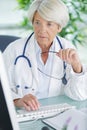 portrait senior doctor sitting in medical office Royalty Free Stock Photo