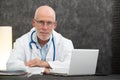 Portrait of senior doctor sitting in medical office Royalty Free Stock Photo