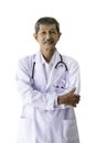 Portrait of a senior doctor smiling and standing hugging his arms in his hospital Royalty Free Stock Photo