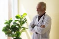 Portrait of senior doctor standing and cross arms at hospital,Happy and positive thinking attitude,Copy space for text Royalty Free Stock Photo
