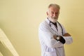 Portrait of senior doctor standing and cross arms looking camera at hospital,Happy and positive thinking attitude,Copy space for t