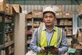 Portrait senior engineer happy working inventory manager. Southeast Asian adult male worker standing in factory store warehouse Royalty Free Stock Photo